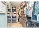 Organized walk-in closet featuring shelves, drawers, hanging rods and plenty of storage space at 1106 Humble Haven St, Ruskin, FL 33570