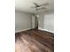Bright bedroom features wood flooring, ceiling fan, and double door closet at 11102 Summer Star Dr, Riverview, FL 33579