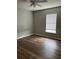 Neutral bedroom with wood floors and a window letting in natural light at 11102 Summer Star Dr, Riverview, FL 33579