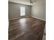 Bright bedroom features wood flooring and a window letting in natural light at 11102 Summer Star Dr, Riverview, FL 33579
