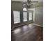 A vacant bedroom with dark wood flooring and large windows for natural light offers space and comfort at 11102 Summer Star Dr, Riverview, FL 33579