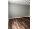 A vacant bedroom with dark wood flooring and a ceiling fan offers a simple and clean aesthetic at 11102 Summer Star Dr, Riverview, FL 33579