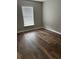 A vacant bedroom offers natural light with dark wood flooring and white window blinds at 11102 Summer Star Dr, Riverview, FL 33579