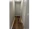 A narrow hallway with dark wood flooring provides access to multiple rooms and closets at 11102 Summer Star Dr, Riverview, FL 33579