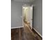 A neutral-toned hallway with dark wood-look flooring offers several storage options and access to other rooms at 11102 Summer Star Dr, Riverview, FL 33579