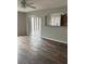 Open living room featuring wood floors, ceiling fan, and arched opening to the kitchen at 11102 Summer Star Dr, Riverview, FL 33579