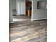 Open living room featuring wood floors, and arched opening to the kitchen, and double door closet at 11102 Summer Star Dr, Riverview, FL 33579