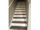 View of stairs with wood treads and white risers, showcasing the home's interior design at 11102 Summer Star Dr, Riverview, FL 33579
