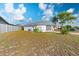 Backyard view reveals the home's rear exterior, a well-maintained fence, and green space at 11305 Brown Bear Ln, Port Richey, FL 34668