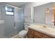 Bathroom features a walk-in shower, updated vanity, and neutral tones for a relaxing atmosphere at 11305 Brown Bear Ln, Port Richey, FL 34668