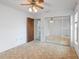 Bedroom featuring a mirrored closet and doorway in a home for sale at 11305 Brown Bear Ln, Port Richey, FL 34668