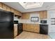 The kitchen features black appliances and bright lighting, enhancing the cooking and meal preparation experience at 11305 Brown Bear Ln, Port Richey, FL 34668