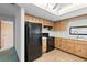 Practical kitchen featuring black appliances, efficient design, and sufficient counter space for easy meal preparation at 11305 Brown Bear Ln, Port Richey, FL 34668