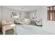 Bright living room with floral furniture, green carpet, and white walls for a clean and airy feel at 11305 Brown Bear Ln, Port Richey, FL 34668
