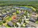 Aerial view of a residential neighborhood close to a scenic lake and lush green tree line at 11408 Coventry Grove Cir, Lithia, FL 33547