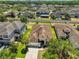 Aerial view of a single-Gathering home with a well manicured lawn in a lovely residential neighborhood at 11408 Coventry Grove Cir, Lithia, FL 33547