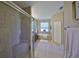 Bathroom featuring a glass-enclosed shower and soaking tub with a window at 11408 Coventry Grove Cir, Lithia, FL 33547