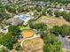 Aerial view of a community recreation center featuring a pool and playground, surrounded by homes at 11408 Coventry Grove Cir, Lithia, FL 33547