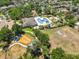 Aerial view of a neighborhood recreation area with a pool and playground with beautiful surrounding homes at 11408 Coventry Grove Cir, Lithia, FL 33547