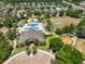 Aerial view of a community recreation center with a resort-style pool, playground, and green space at 11408 Coventry Grove Cir, Lithia, FL 33547