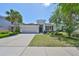 Beautiful single-story home featuring a well-manicured lawn, inviting entrance, and attached two-car garage at 11408 Coventry Grove Cir, Lithia, FL 33547
