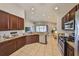 Updated kitchen with stainless steel appliances, granite counters, and dark wood cabinets, opening to the living area at 11408 Coventry Grove Cir, Lithia, FL 33547