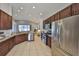 Modern kitchen featuring stainless steel appliances, granite countertops, and ample dark wood cabinetry at 11408 Coventry Grove Cir, Lithia, FL 33547
