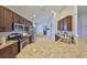 Open kitchen features stainless steel appliances, granite countertops, and dark wood cabinetry at 11408 Coventry Grove Cir, Lithia, FL 33547