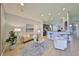 Stylish living room with tile floors, a comfortable sofa, and an open layout that flows into the kitchen at 11408 Coventry Grove Cir, Lithia, FL 33547