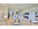 Open-concept living room with tile flooring, comfortable seating, and a view into the kitchen at 11408 Coventry Grove Cir, Lithia, FL 33547