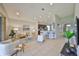 Open-concept living room with tile floors, recessed lighting, and a view into the kitchen with bar seating at 11408 Coventry Grove Cir, Lithia, FL 33547
