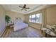 Bright and airy bedroom boasts wood floors, a ceiling fan, and a window providing natural light at 11408 Coventry Grove Cir, Lithia, FL 33547