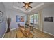 Well-lit office space featuring a desk, comfortable seating, and a ceiling fan at 11408 Coventry Grove Cir, Lithia, FL 33547