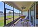 Enclosed patio featuring an outdoor seating area with a view of the backyard at 11408 Coventry Grove Cir, Lithia, FL 33547