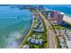 Overhead view featuring waterfront condos, a road, parking and coastline views at 1351 Gulf Blvd # 209, Clearwater Beach, FL 33767