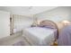 Bedroom with woven headboard, ceiling fan, and large closet at 1351 Gulf Blvd # 209, Clearwater Beach, FL 33767