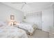 Bedroom with twin beds, ceiling fan, and closet with mirrored doors at 1351 Gulf Blvd # 209, Clearwater Beach, FL 33767