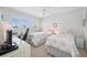 Bright bedroom with twin beds, a ceiling fan, and windows with scenic views at 1351 Gulf Blvd # 209, Clearwater Beach, FL 33767