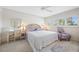 Bedroom with woven headboard, desk area, ceiling fan, and natural light at 1351 Gulf Blvd # 209, Clearwater Beach, FL 33767