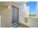 Property entrance featuring secure door, exterior lighting, and a fire extinguisher at 1351 Gulf Blvd # 209, Clearwater Beach, FL 33767