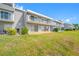 Well-maintained condominium exterior with lush green lawn and balcony views at 1351 Gulf Blvd # 209, Clearwater Beach, FL 33767
