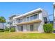 Attractive condo building with balconies, landscaping, and outdoor space at 1351 Gulf Blvd # 209, Clearwater Beach, FL 33767
