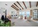 Bright living room featuring a vaulted ceiling, ceiling fan, and sliders to the balcony with water views at 1351 Gulf Blvd # 209, Clearwater Beach, FL 33767