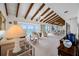Spacious living room with vaulted ceilings, exposed beams, and sliding glass doors to waterfront balcony at 1351 Gulf Blvd # 209, Clearwater Beach, FL 33767