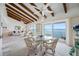 Bright open living space with beamed ceilings, water views, and access to the balcony at 1351 Gulf Blvd # 209, Clearwater Beach, FL 33767