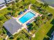Birds-eye view of pool area surrounded by lush landscaping, lounge chairs, and a sheltered pavilion at 1351 Gulf Blvd # 209, Clearwater Beach, FL 33767