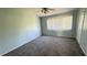 Bedroom featuring neutral paint, a ceiling fan, and natural light from the window at 1400 Costa Mesa Dr, Wesley Chapel, FL 33543