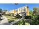 Well-maintained two-story townhome with lush green lawn and mature landscaping at 1400 Costa Mesa Dr, Wesley Chapel, FL 33543