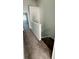 Hallway leading to stairs with neutral paint and plush carpeting at 1400 Costa Mesa Dr, Wesley Chapel, FL 33543