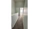 Carpeted hallway with access to rooms, featuring a neutral color palette and natural light, creating a warm, inviting atmosphere at 1400 Costa Mesa Dr, Wesley Chapel, FL 33543